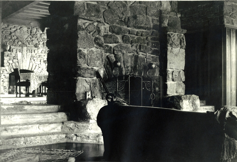 Manor House living room fireplace. Genevieve hand selected lichen-covered rocks from the property and directed each one’s placement within eight massive fireplaces. Genevieve,
eager to supervise construction, stayed on-sight in a canvas
tent. Other tents were erected for her daughters, the maid, workmen and a cook tent for meal service. Credit: Roberts Family Collection